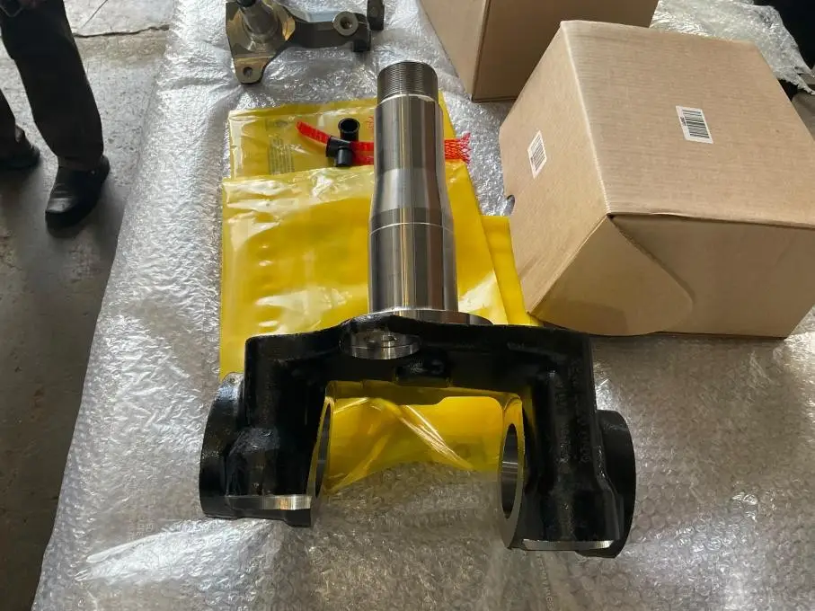B7 · T1 first article · single forged knuckle wrapped in plastic with shipping carton, dimensional sample