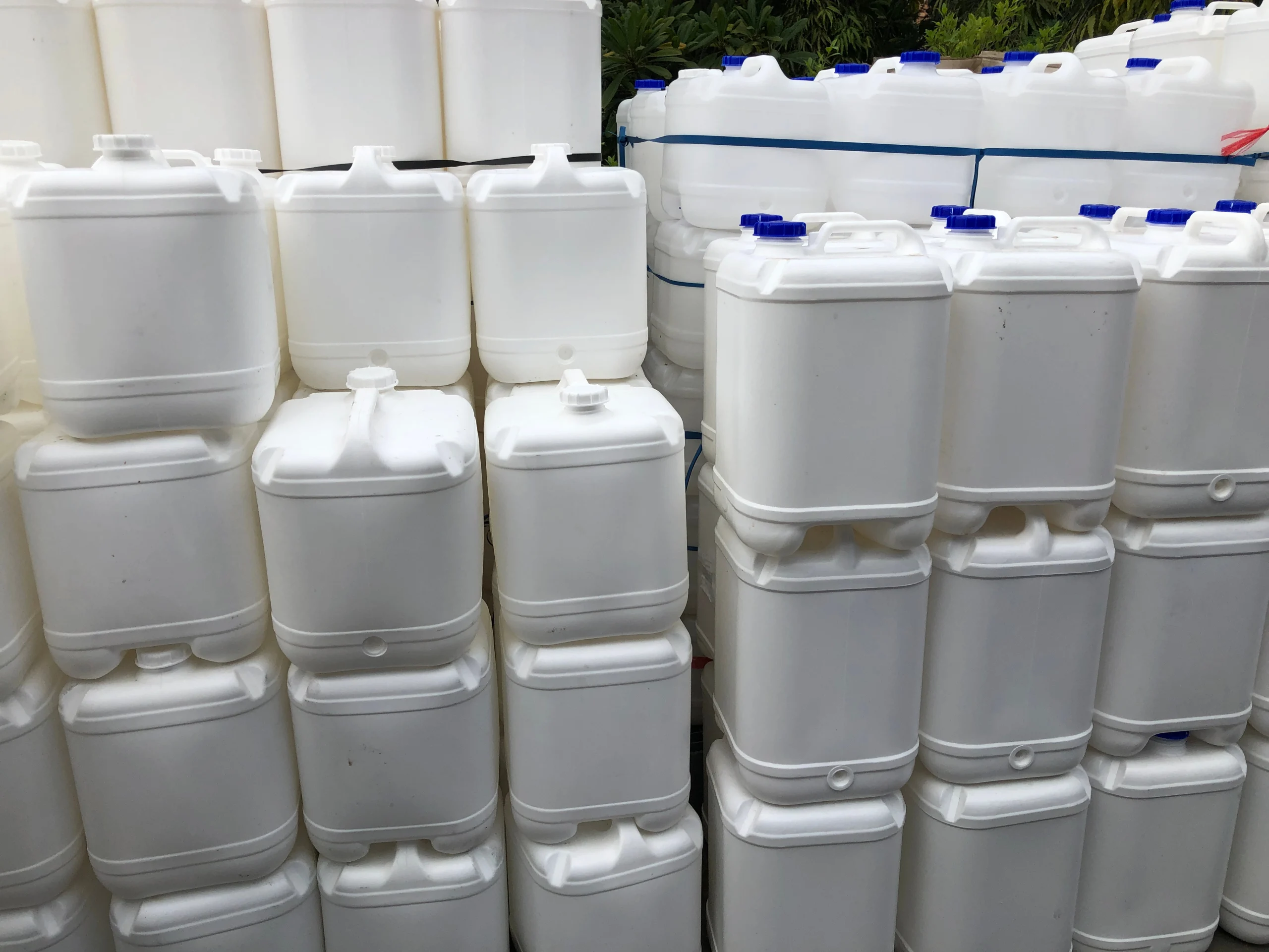 Blow molded plastic drums and barrels lined up at our India partner facility after trimming