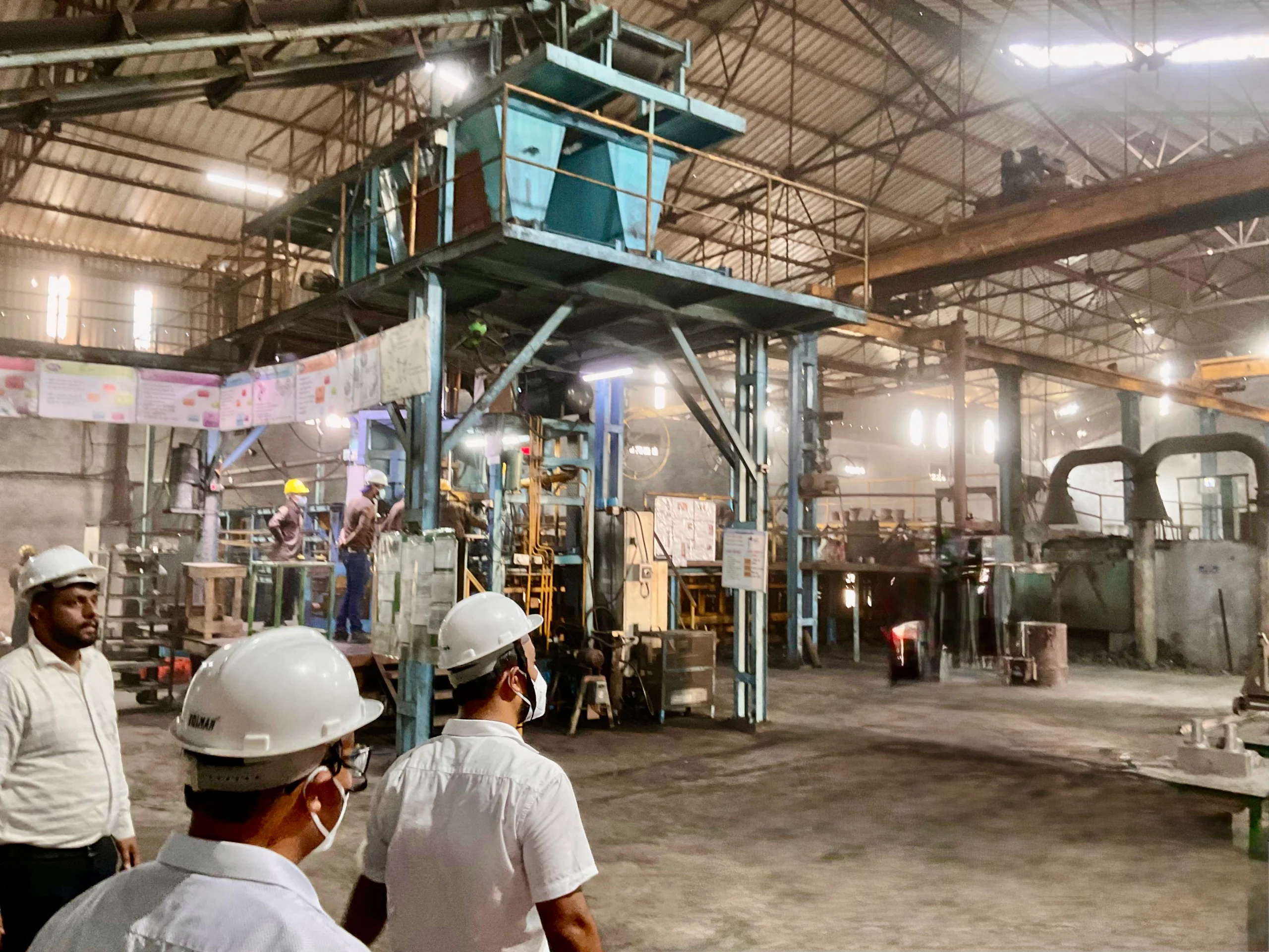 VIA INDIGOS audit team in hard hats inspecting a casting plant floor in India