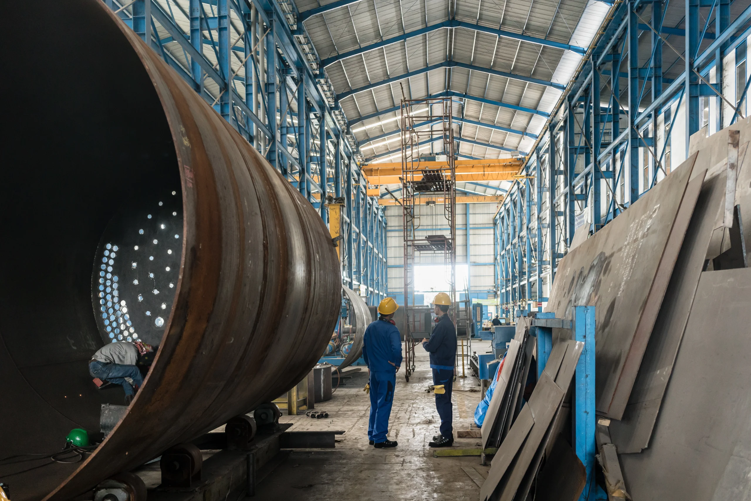Wide view of the sheet metal fabrication floor at our India partner facility, cutting forming and welding under one roof