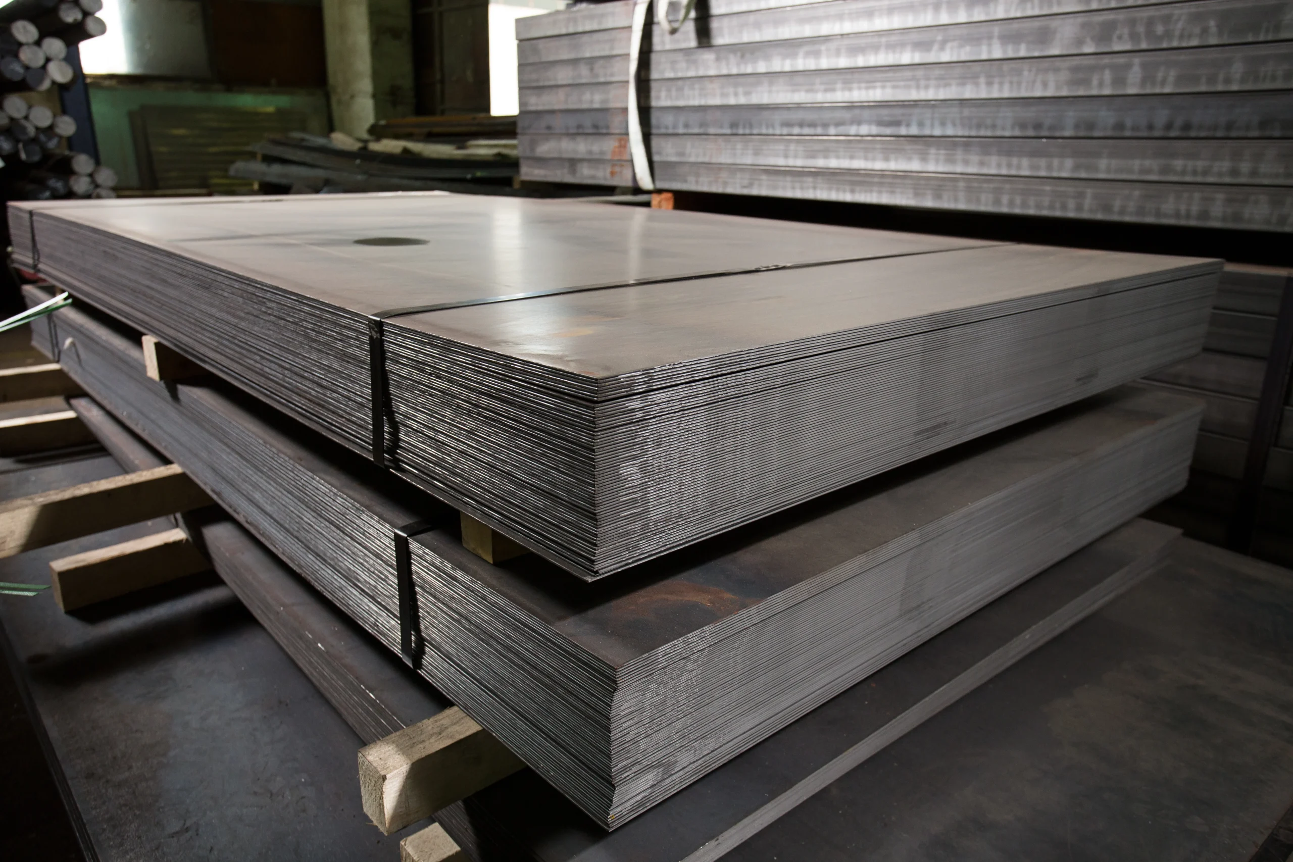 Stacks of raw hot rolled steel plate, the input material cut and welded into fabricated structural steel, at our India partner facility