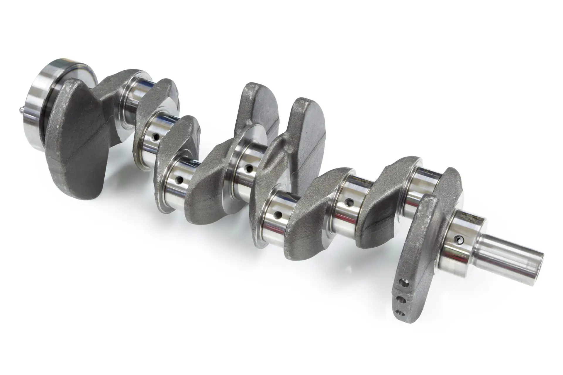 Forged automotive crankshafts after heat treatment, staged for machining and hardness testing at a VIA INDIGOS partner forging plant in India