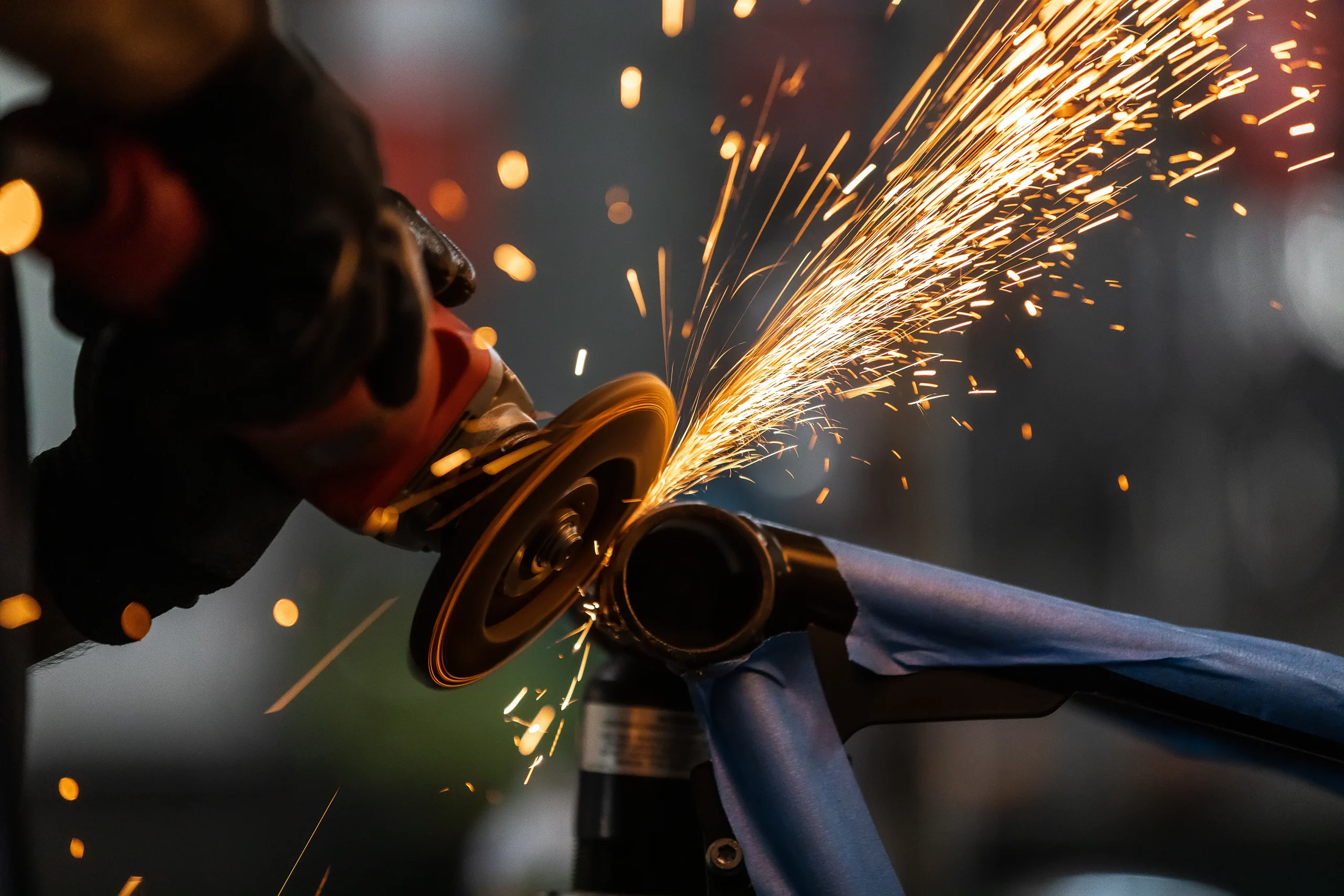 Grinding and dressing a welded steel joint on the fabrication floor at our India partner facility