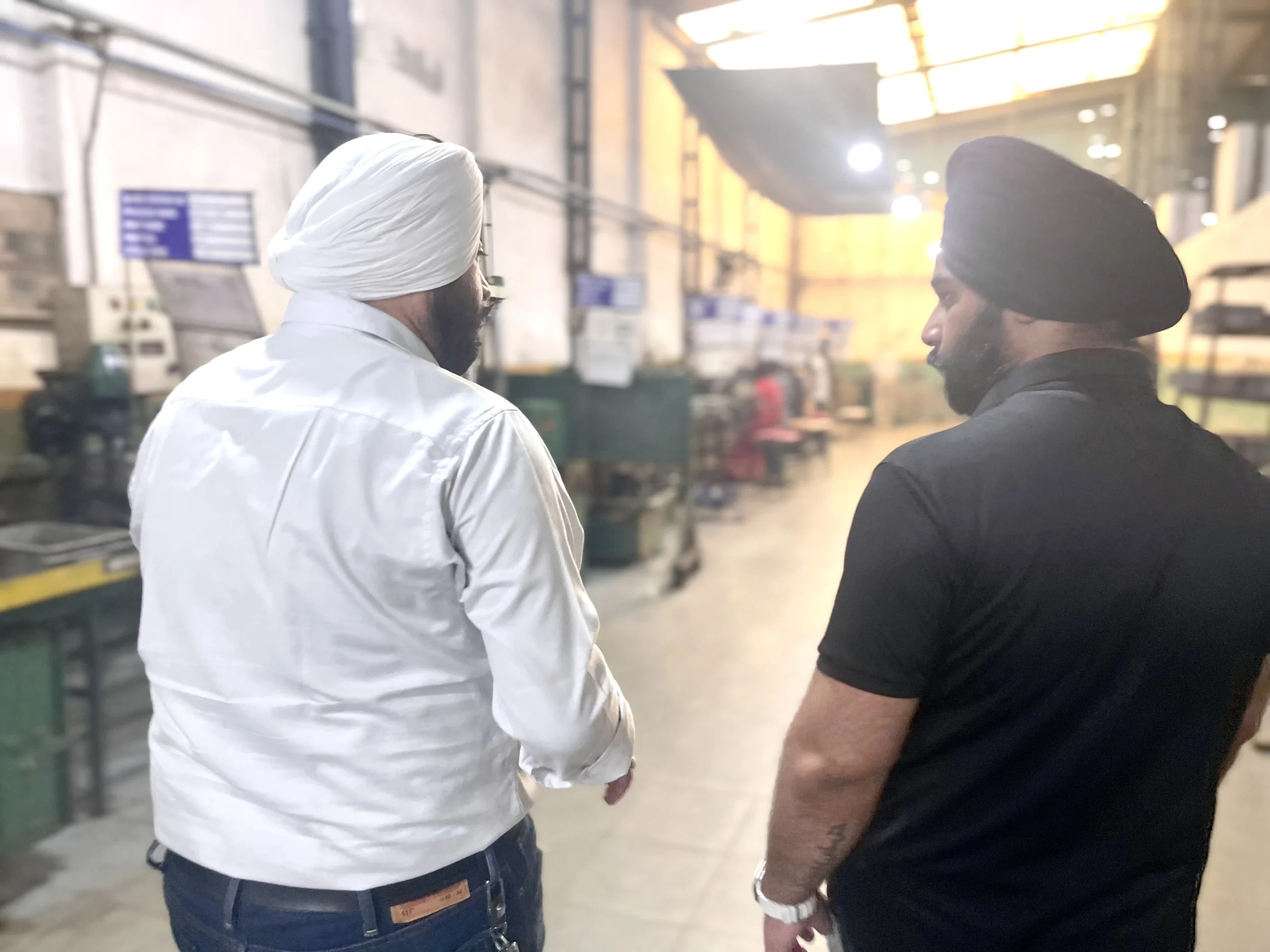 Our quality lead inspecting on the stamping floor at our India partner facility, checking tonnage and die setup before the first PO