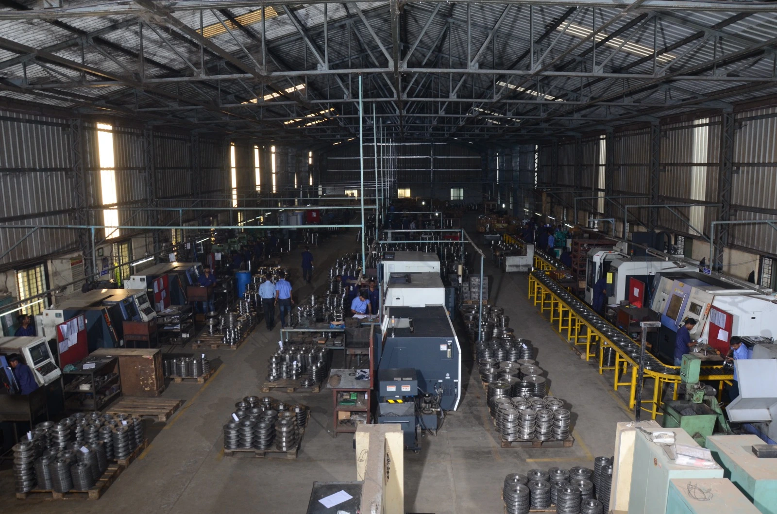 Wide view of our partner CNC and VMC machining plant in India, rows of machines on the production floor