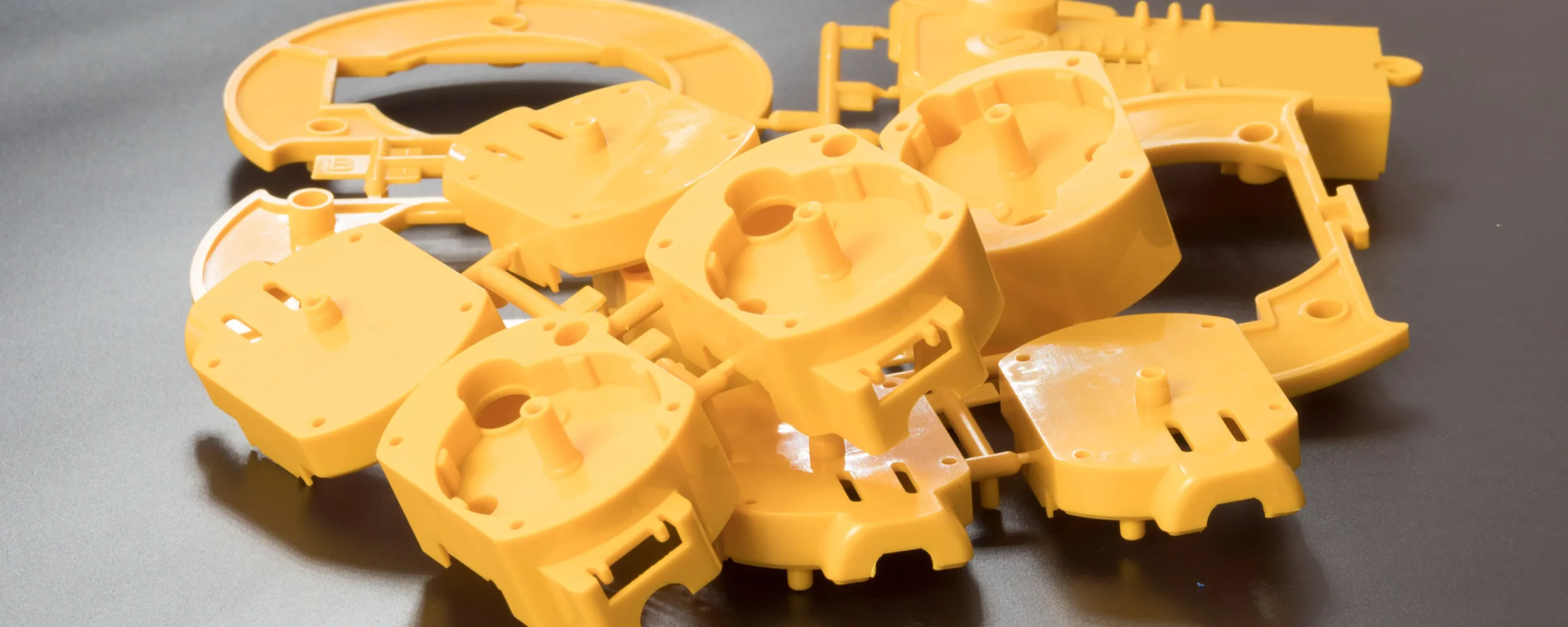 Injection molded yellow parts staged at our India partner facility, degated and ready for inspection