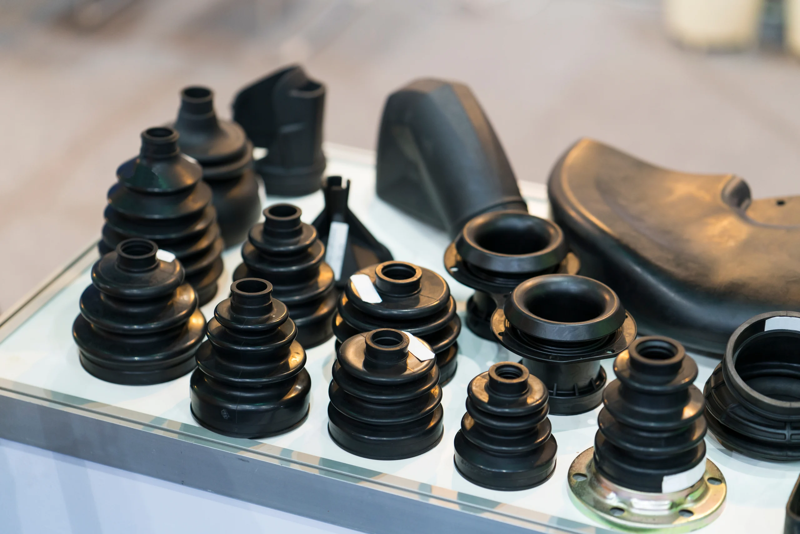 Precision molded rubber boots and bellows laid out after curing at our India partner facility