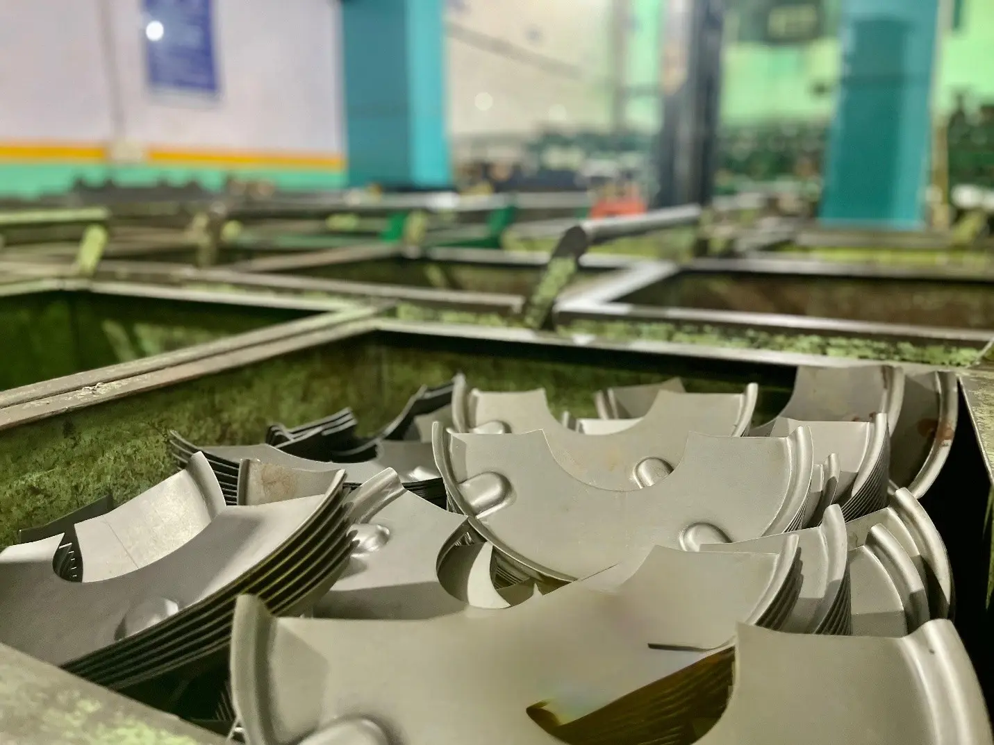 Progressive die stamped sheet metal automotive components after blanking and forming at a VIA INDIGOS partner stamping plant in India