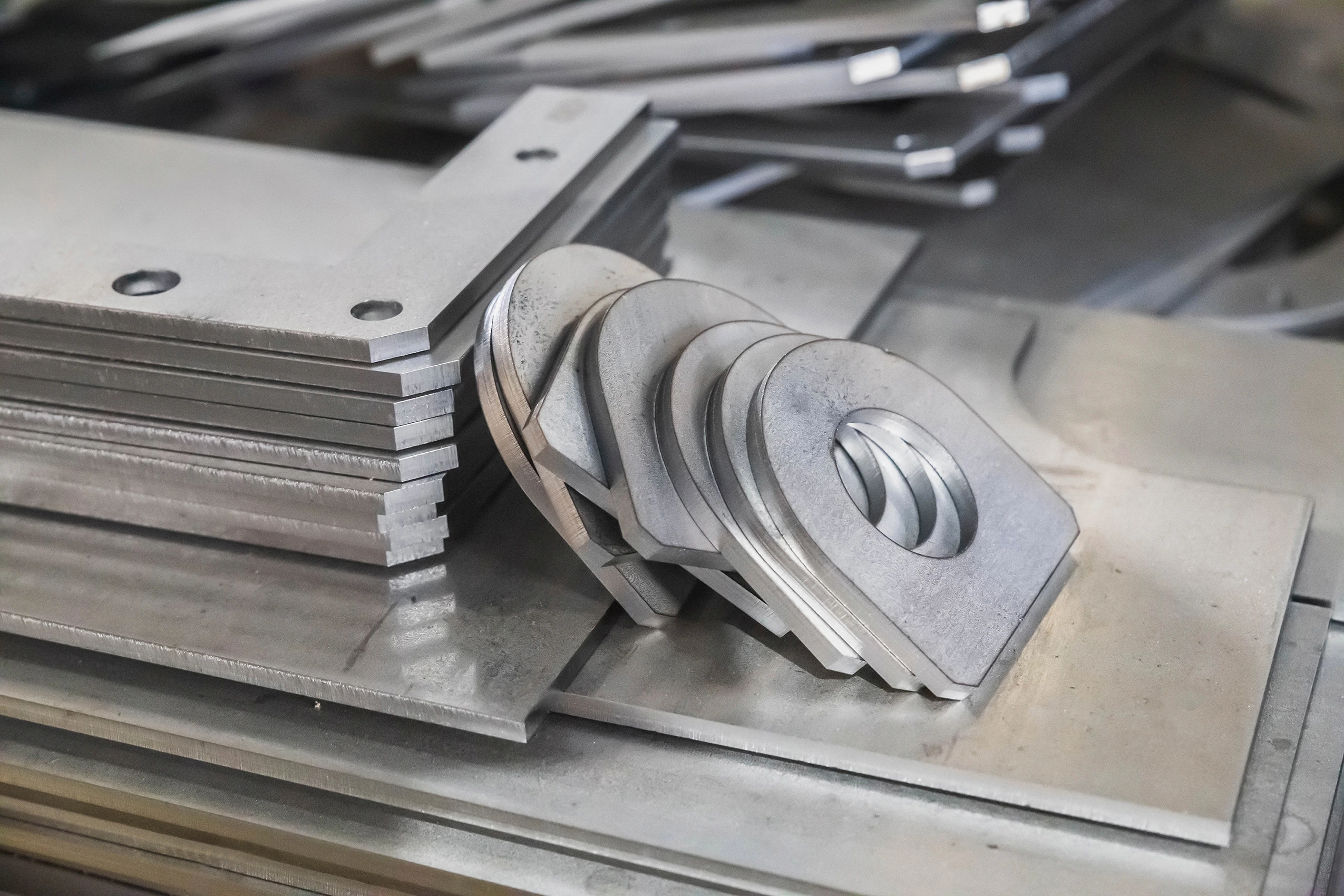 Blanked sheet metal parts coming off the die at our India partner facility
