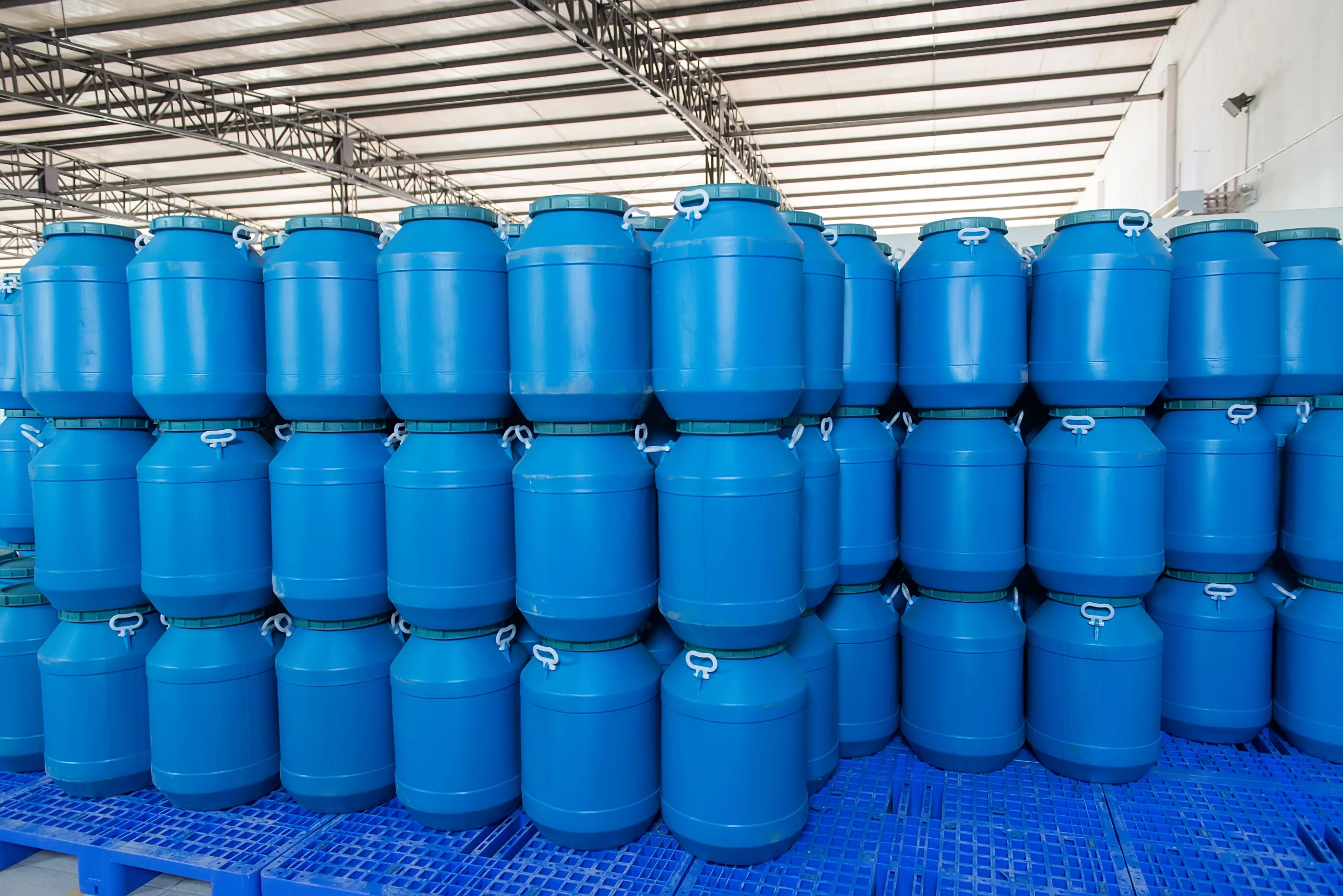 Blow molded HDPE jerry cans and water containers staged for leak testing at our India partner facility