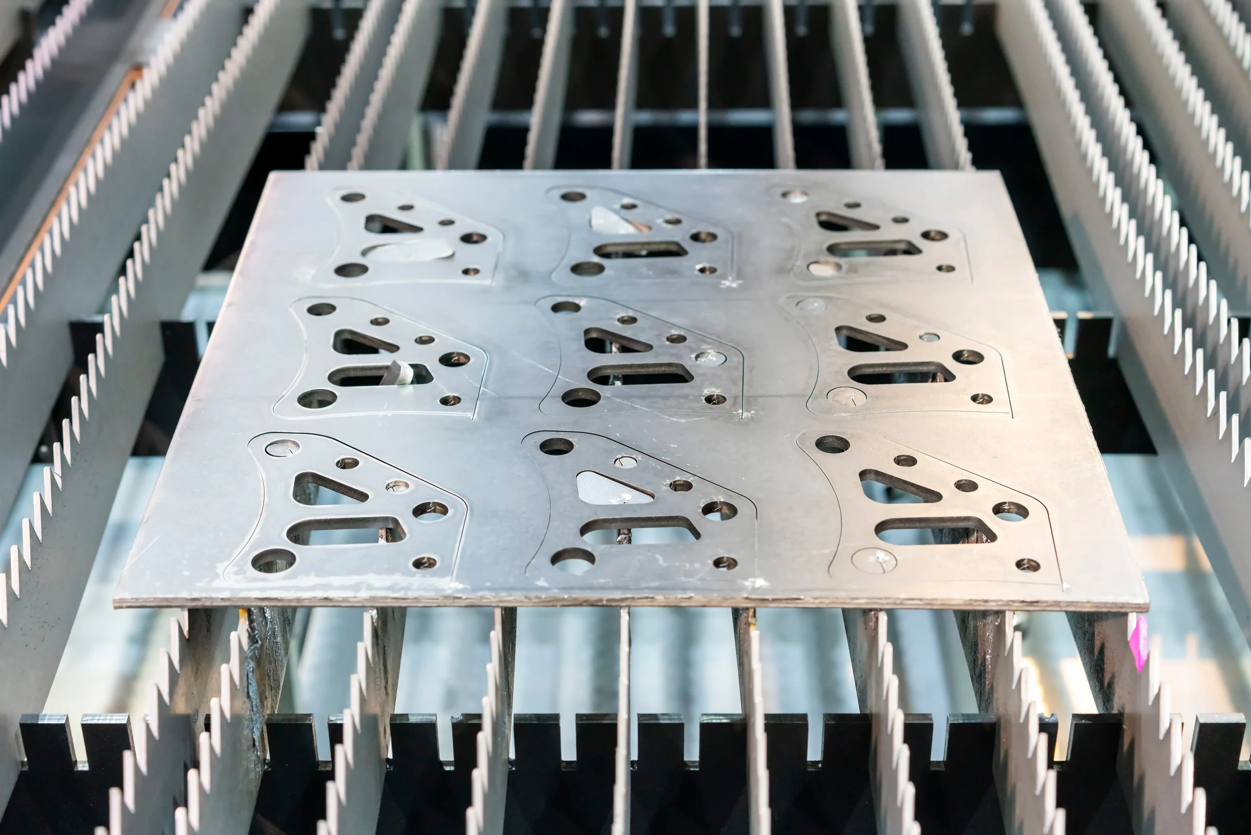 Fiber laser cutting nested profiles from flat steel sheet at our India partner facility