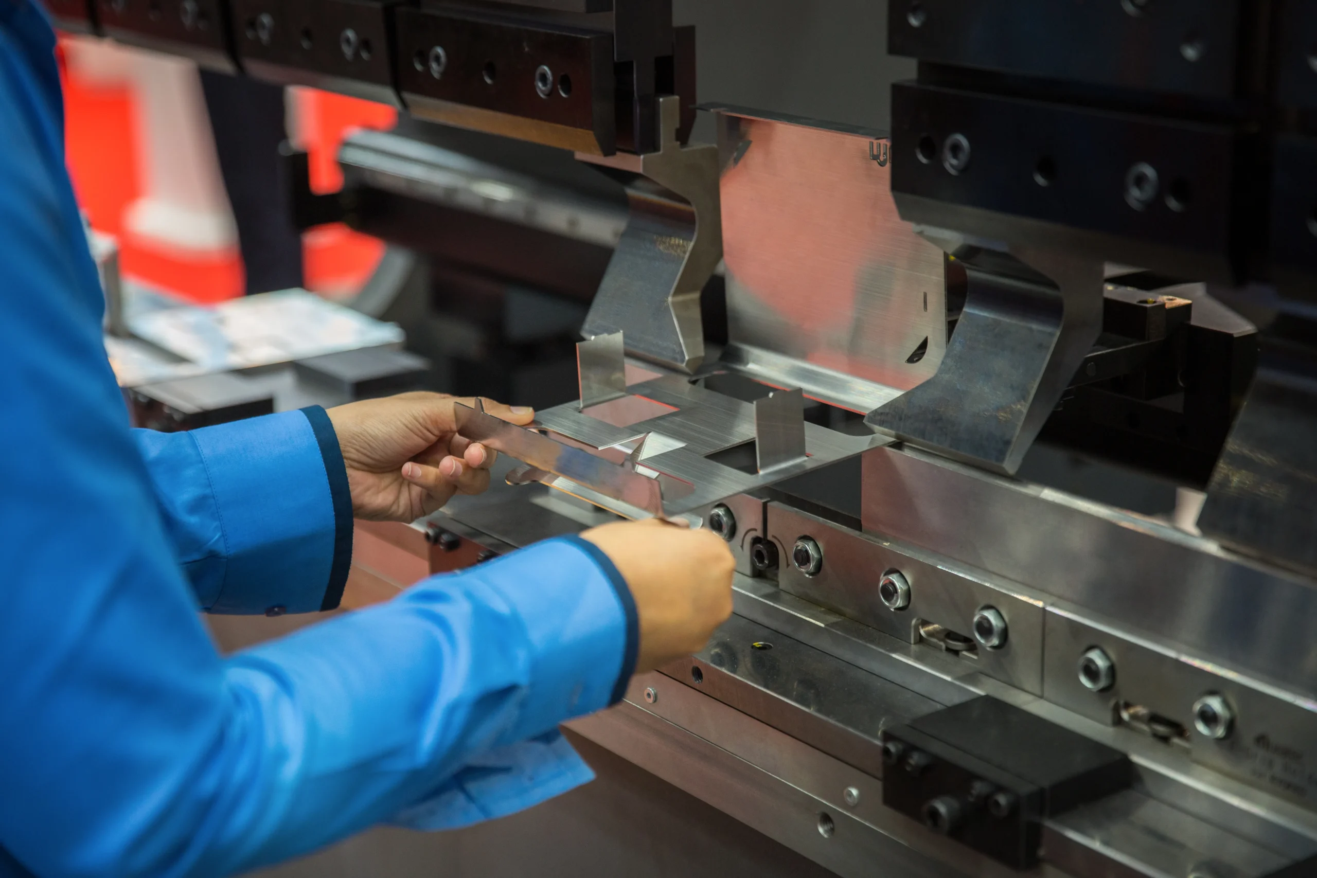 A CNC press brake forming a steel bracket on the floor at our India partner facility, where we walk the line before a single PO