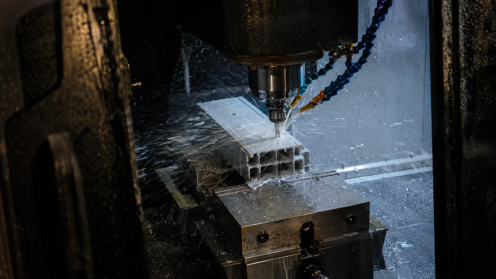 CNC machining center milling and drilling an extruded aluminum profile in a soft jaw fixture at our India partner facility