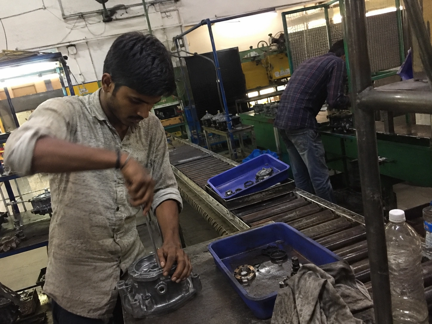 Assembly technicians building gear units at press and torque stations during a production run at our India partner facility