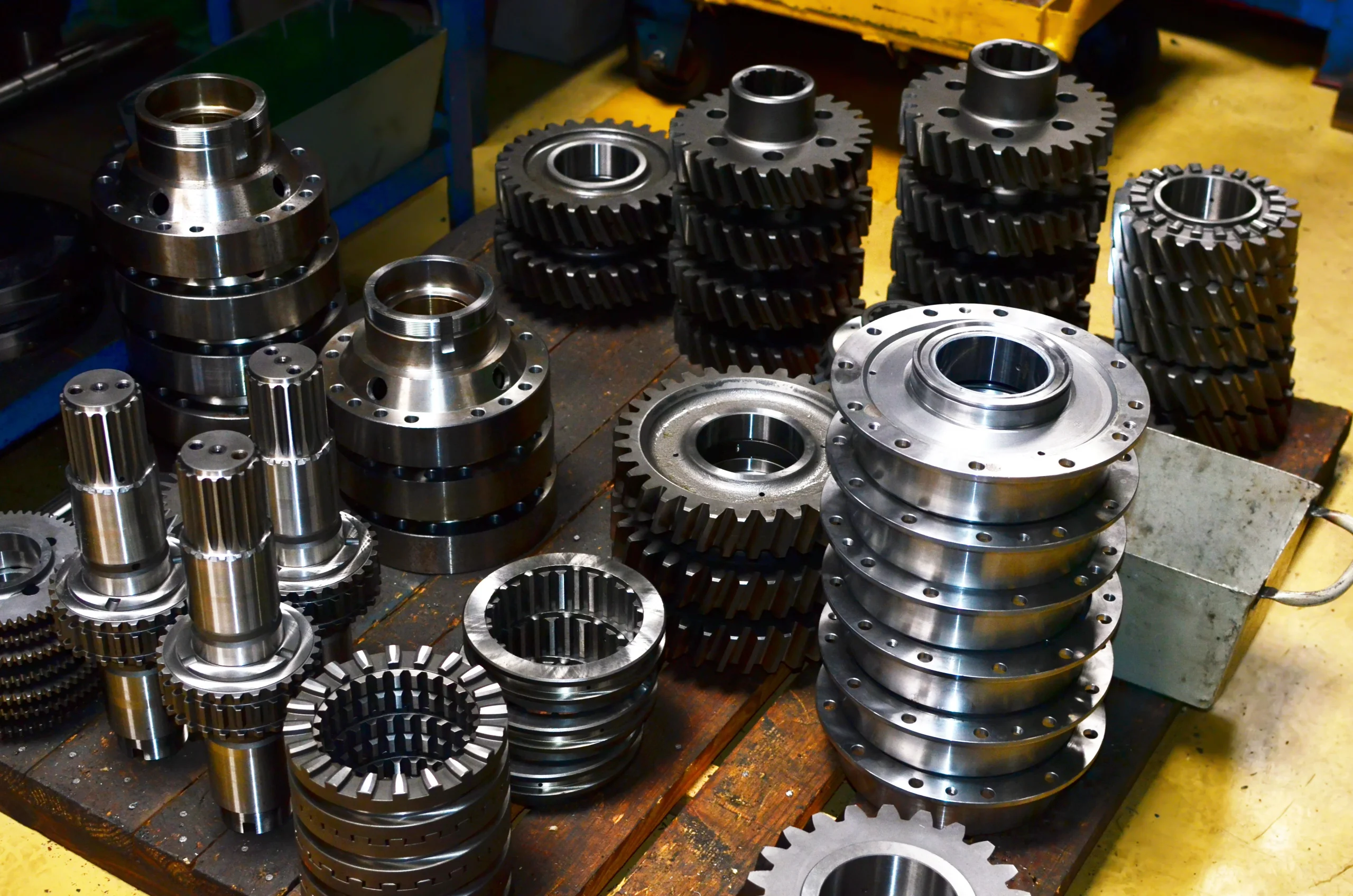 Machined gears, hubs and splined agricultural components stacked after turning and hobbing at a VIA INDIGOS partner machining plant in India