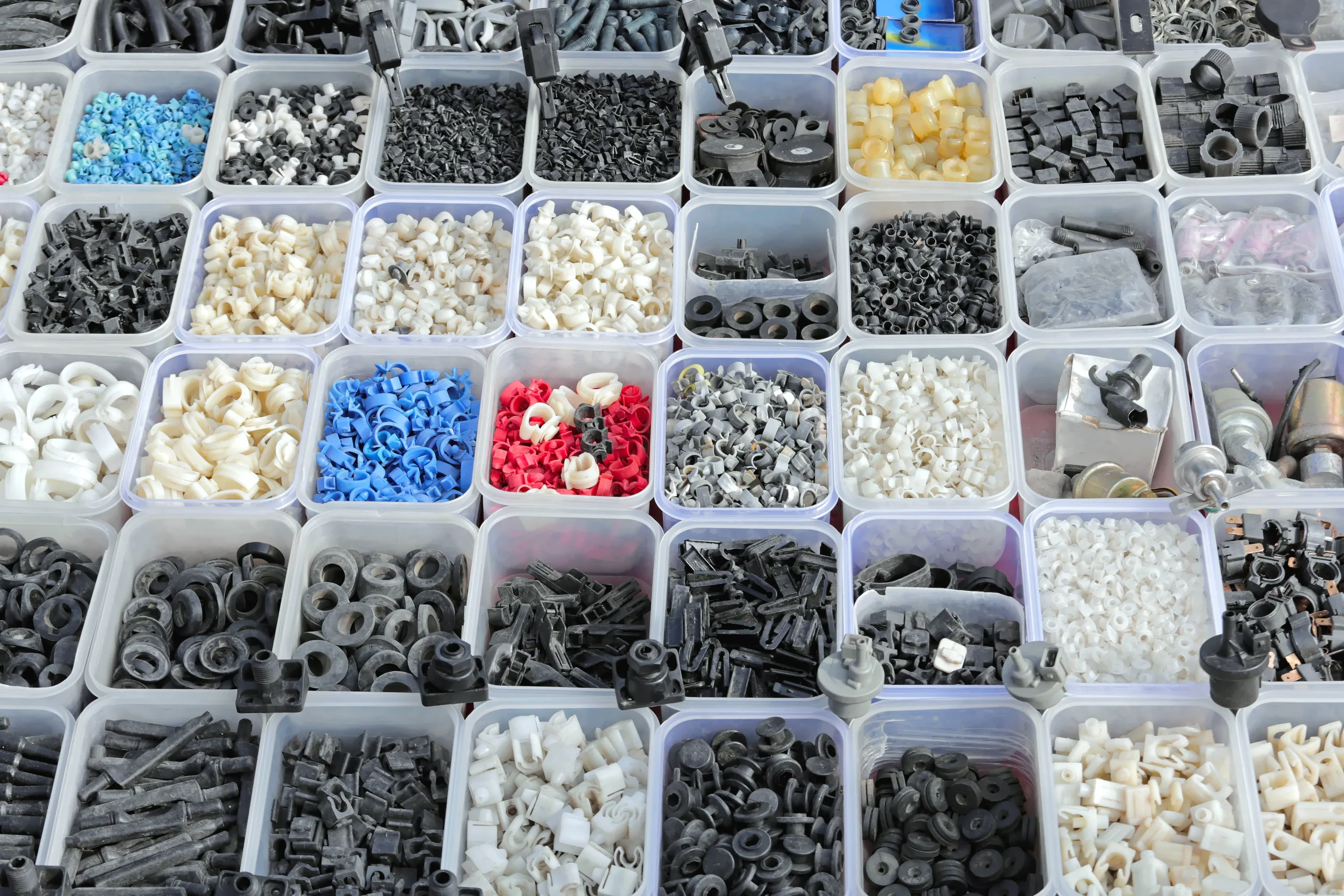 Kitting bins of sorted fasteners, seals, and small child parts staged for one assembly build at our India partner facility